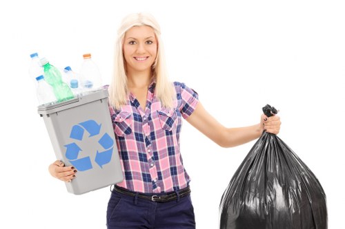 Worker wearing PPE handling waste during an apartment clearance